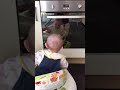 BABY LAUGHING AT HERSELF IN THE OVEN MIRROR