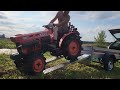 Compact tractor Kubota B6001 driving to trailer for transportation