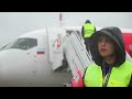 Su SuperJet-100 meet on the airport apron. New Red Wings flight. Rainy day.