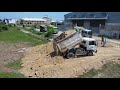 Processing a large landfill with a Komatsu D58E bulldozer, pushing soil by 5ton dump trucks.Mix 2VDO