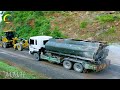 Amazing construction site with heavy machinery, SANY grader, and roller actively working on a road