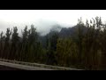 Trucking, clouds hugging the cliff tops.