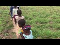 Mubende District Villagers trekking toward water site with Wells of Life