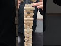 playing Jenga just got more competitive and he wants a round 2