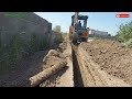 Backhoe loader working excavation for new installation underground electrical cable