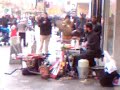 Glasgow street drummer Christmas 2013 with streetsign and wheelbarrow drums