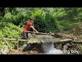 The boy used the net to make a trap to catch fish in the stream.