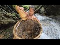 Vietnamese girl goes alone into the forest to trap frogs with a bamboo basket to make a living