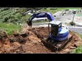 Mini Excavator Working On The Road Cliff Making A New Entrance