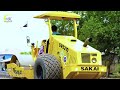 The video shows road construction equipment working on leveling gravel in the road-building process