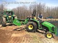 John Deere tractor towing out of water