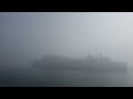 Submarine tender USS Emory S Land in thick fog.