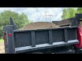 Homemade topsoil screen in use and   loading truck, BOBCAT T62 on a hot