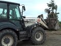 Dressta earth mover and Terrex backhoe loader spreading gravel