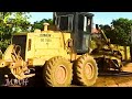 Amazing a yellow grader and a yellow road roller are working on the village's old road construction