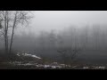 Windmill on foggy snow covered mountain