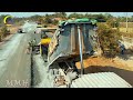 Road Construction in Rural The process of moving gravel with trucks to transfer in a paver machine