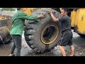Auto repair: how a talented mechanic changes the tire of a giant 30-ton excavator