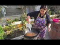 Azerbaijani Woman Cooking Uzbek Pilaf on a Fire in the Village Outdoors