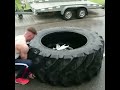 Man Demonstrates Intense Tire Flipping Workout Routine