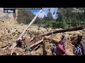 People in Papua New Guinea dig through mud and debris after huge landslide
