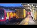 Two freight trains rushing by Barking Station.