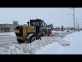 Snow Removal CAT Grader Working In Heavy Snow