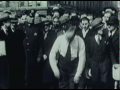 1930's strong man pulls plane and ship with his teeth.avi