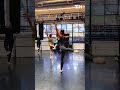 Woman Practices Ballet While Holding Her Baby in Baby Carrier