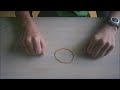 Floating rubber band (magic trick)