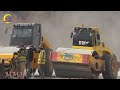 Wonderful a new road construction in a mountainous area. A large paver machine on a gravel process