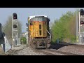 A long freight train with a DPU runs through on the siding as the local works the Main line