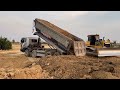 Bulldozer SHANTUI Clearing Land And Fores Tree With DumpTruck TRAGO DONGFENG HYUNDAI 25TON Unloading