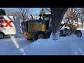 Snow Removal CAT and Deere Graders Plowing Heavy Snow In Saskatoon