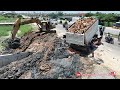 Dump Truck HINO 5T​ dumping soil with Komatsu D31p dozer push mud clear on sewer next the road