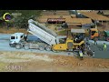 The process of road building with heavy machines working on a road. Gravel paving machine technology