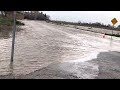 Car Drives Through a Flooded Road in California