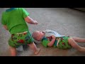 Twin boys playing with their Boston Terrier dog