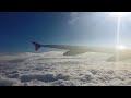 Airplane taking off & ascending above the clouds