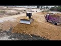Activities  Pour soil  to bury the fields by Bulldozer Komatsu with 25 ton Dump Truck