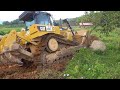 #CATD6R2 #bulldozer trying to remove massive rock in the middle of the road.